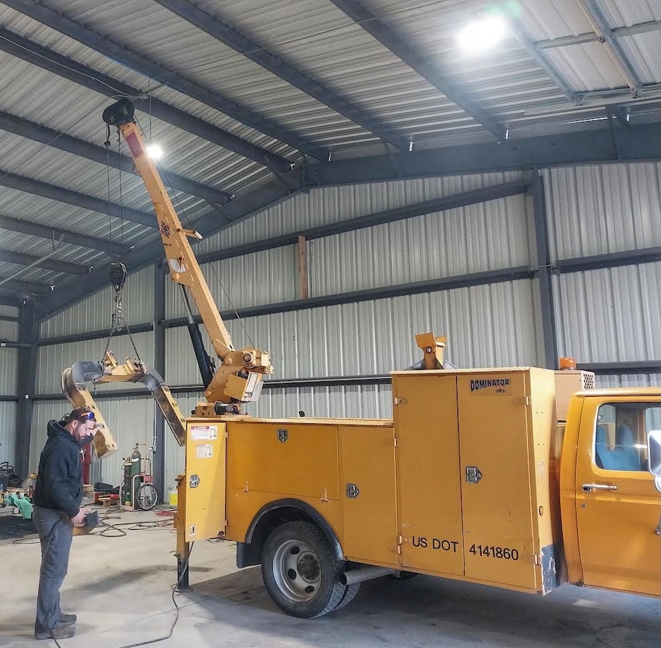 Sky Equipment Services technician working inside a warehouse facility